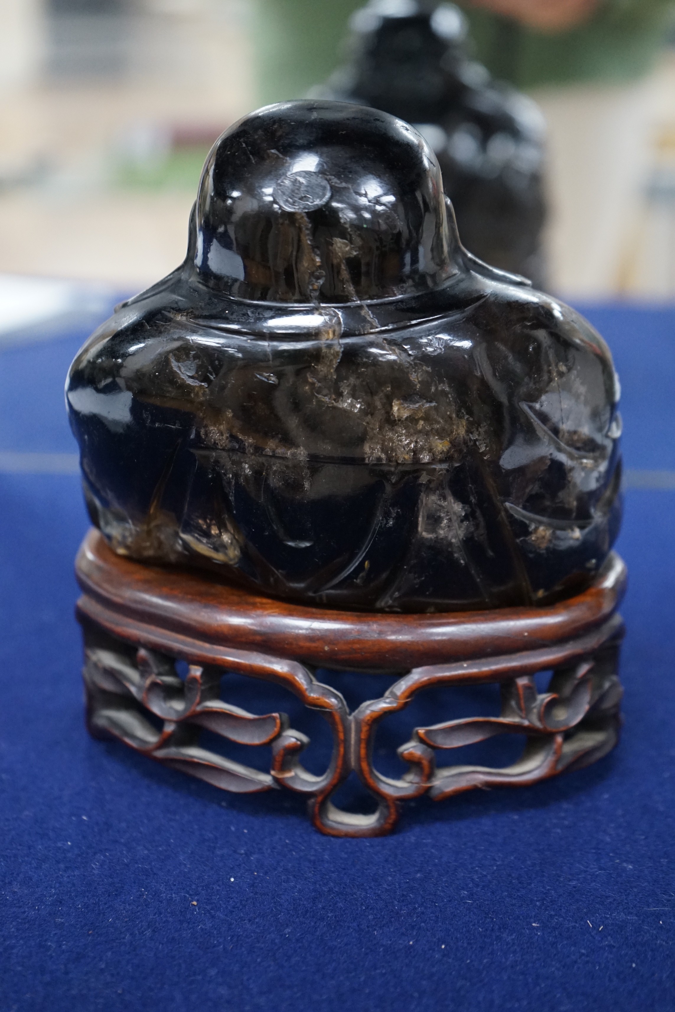 A large Chinese smoky quartz figure of Budai, 17cm tall including wood stand